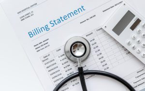 A medical bill from the hospital with a doctor's stethoscope and calculator.
